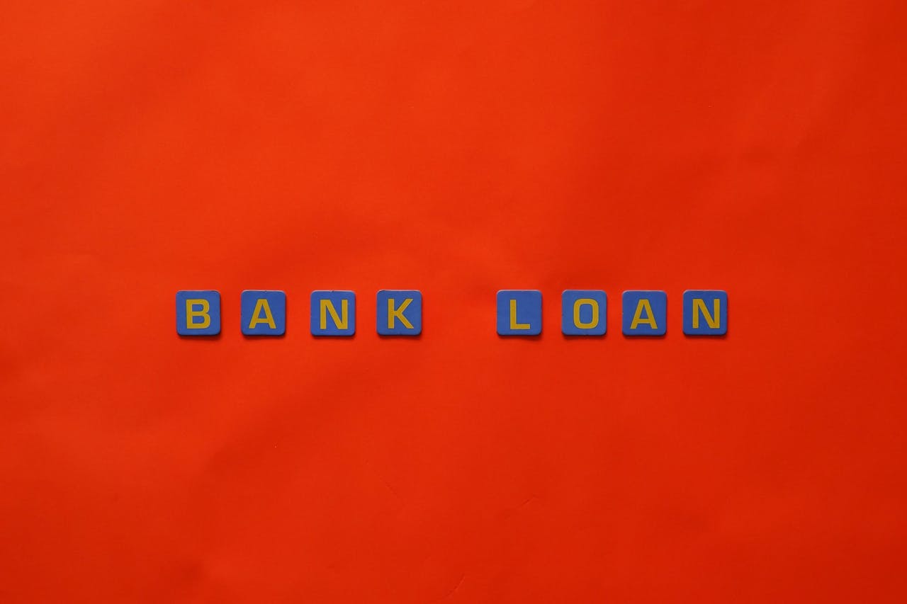 Letters forming 'Bank Loan' on a vibrant red surface, ideal for finance themes.